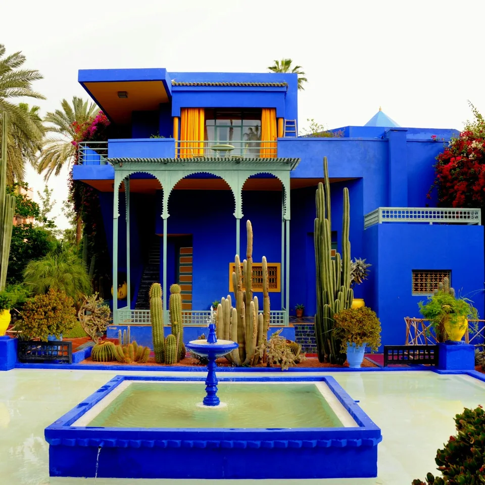 Blue courtyard fountain and yellow doors at Jardin Majorelle