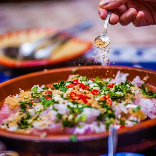 Seasoning sprinkled over a colourful Moroccan dish